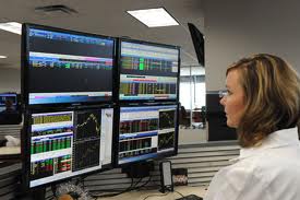 forex trader in front of screens