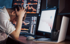 an emotional trader looks at his screen in despair